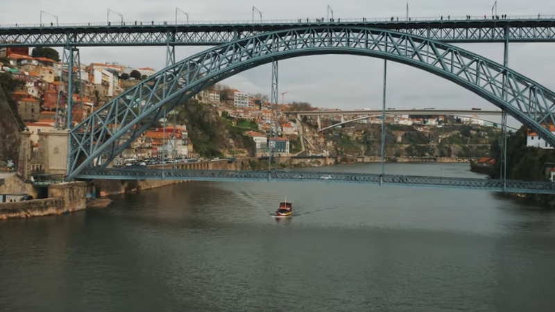 A Scenic View of Porto, Portugal, Featuring the Iconic Bridge, Perfect for Those Exploring Visa Options for Relocating to Portugal